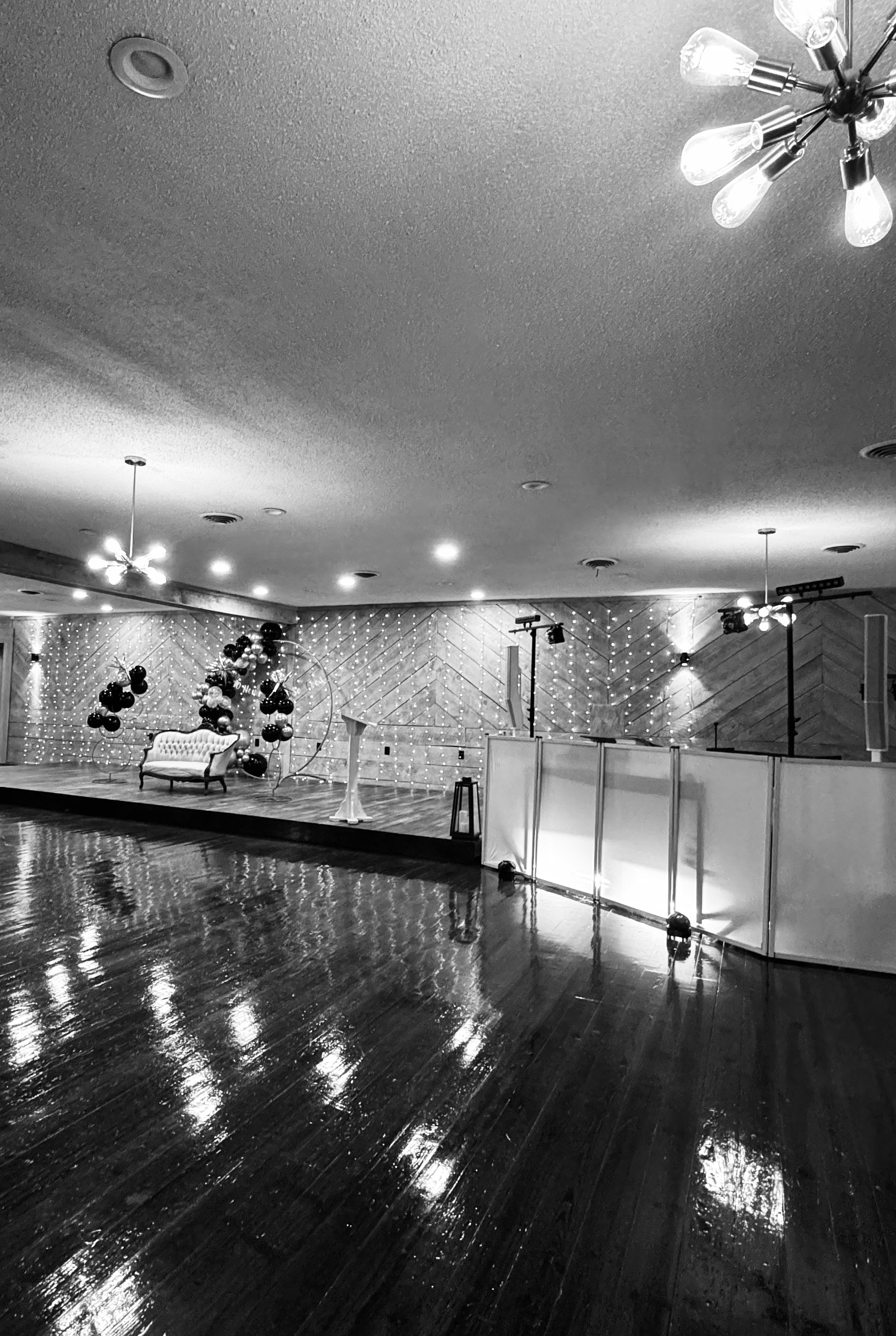 Corporate event setup with balloon backdrop and white DJ booth